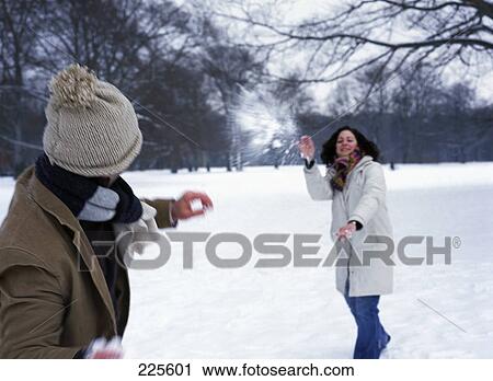 Mid adult couple having snowball fight View Large Photo Image Stock Image - Mid adult couple having snowball fight . Fotosearch