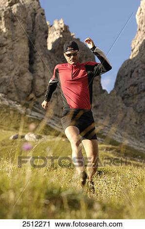 Mid adult man running on landscape, Trentino-Alto Adige, Italy View Large Photo Image Stock Image - Mid adult man running on landscape, Trentino-Alto Adige, Italy . Fotosearch