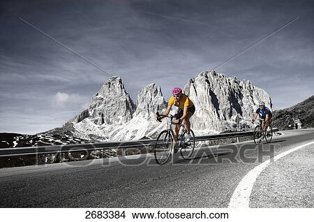 Picture - Mountain biker in motion on country road, Dolomites, Italy . Fotosearch