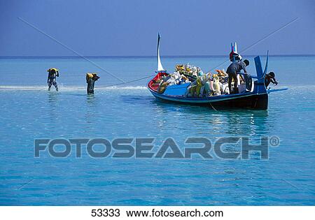 Stock Image - Native people on boat, Maldives . Fotosearch