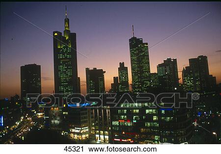 Stock Image - Office buildings lit up at dusk, Hauptwache, Frankfurt, Hesse, Germany . Fotosearch