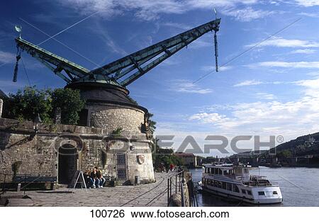 Stock Photograph - Old crane on riverbank, Wuerzburg, Franconia, Bavaria, Germany . Fotosearch