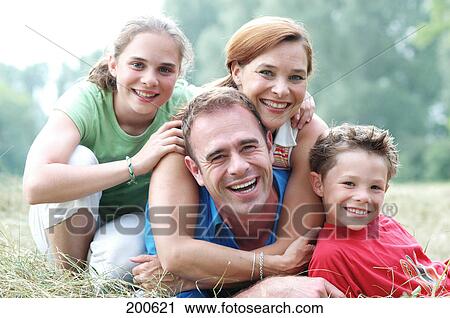 Stock Image - Parents with son and daughter outside . Fotosearch