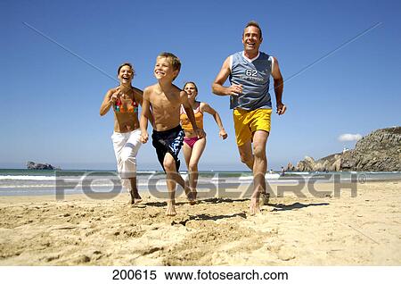 Parents with son and daughter running at beach View Large Photo Image Stock Photography - Parents with son and daughter running at beach . Fotosearch