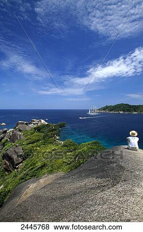 Person sitting on coast, Similan Islands, Phuket Province, Thailand View Large Photo Image Stock Photo - Person sitting on coast, Similan Islands, Phuket Province, Thailand . Fotosearch