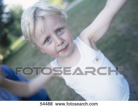 Stock Photo - Portrait of a boy looking sceptical . Fotosearch
