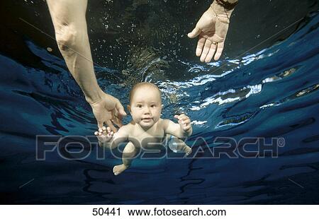 Stock Image - Portrait of baby boy swimming underwater . Fotosearch
