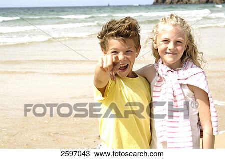 Portrait of boy and girl smiling on beach View Large Photo Image Stock Image - Portrait of boy and girl smiling on beach . Fotosearch
