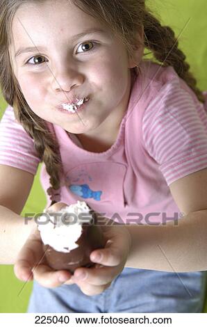 Stock Image - Portrait of boy eating cake . Fotosearch