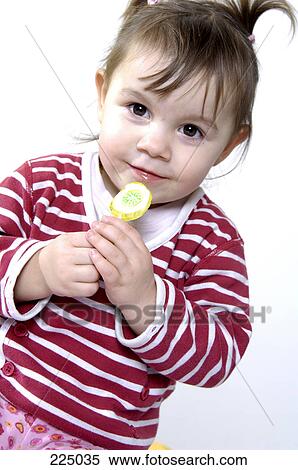 Portrait of girl holding lollipop View Large Photo Image Stock Photography - Portrait of girl holding lollipop . Fotosearch