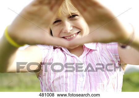 Portrait of girl looking through hand frame View Large Photo Image Stock Photo - Portrait of girl looking through hand frame . Fotosearch