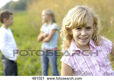 Portrait of girl smiling in field View Large Photo Image Stock Image - Portrait of girl smiling in field . Fotosearch