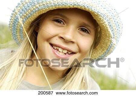 Portrait of girl smiling in field View Large Photo Image Stock Photo - Portrait of girl smiling in field . Fotosearch