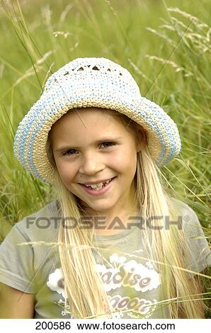 Portrait of girl smiling in field View Large Photo Image Stock Photograph - Portrait of girl smiling in field . Fotosearch