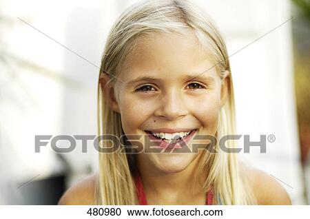 Stock Image - Portrait of girl smiling . Fotosearch