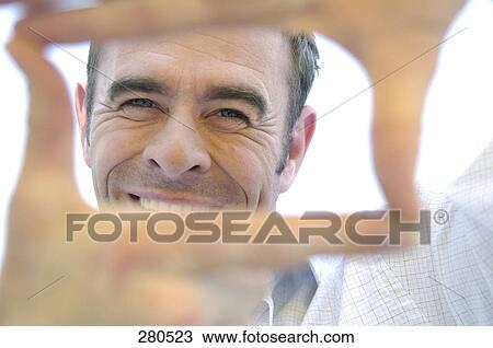 Portrait of mature man making frame with fingers View Large Photo Image Stock Image - Portrait of mature man making frame with fingers . Fotosearch
