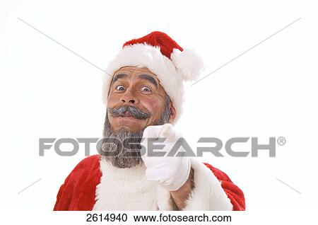 Stock Image - Portrait of senior man in santa costume pointing . Fotosearch