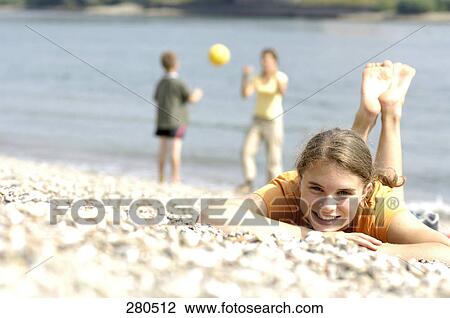Portrait of teenage girl lying on beach and smiling View Large Photo Image Stock Image - Portrait of teenage girl lying on beach and smiling . Fotosearch