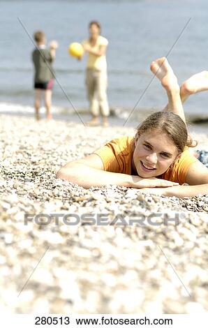 Portrait of teenage girl lying on beach and smiling View Large Photo Image Stock Image - Portrait of teenage girl lying on beach and smiling . Fotosearch
