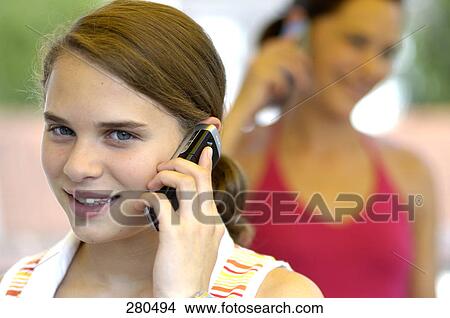 Picture - Portrait of teenage girl talking on mobile phone . Fotosearch