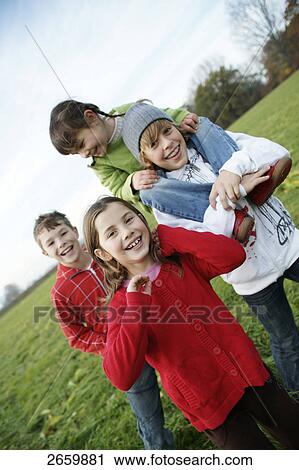 Portrait of two boys and girls smiling View Large Photo Image Stock Image - Portrait of two boys and girls smiling . Fotosearch