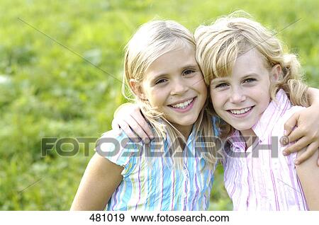 Portrait of two girls smiling View Large Photo Image Stock Photo - Portrait of two girls smiling . Fotosearch
