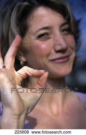 Portrait of woman showing ok-sign View Large Photo Image Stock Photo - Portrait of woman showing ok-sign . Fotosearch
