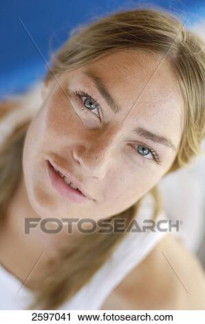 Stock Image - Portrait of young woman smiling . Fotosearch