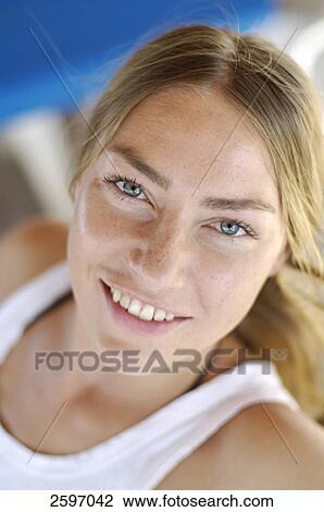 Stock Image - Portrait of young woman smiling . Fotosearch