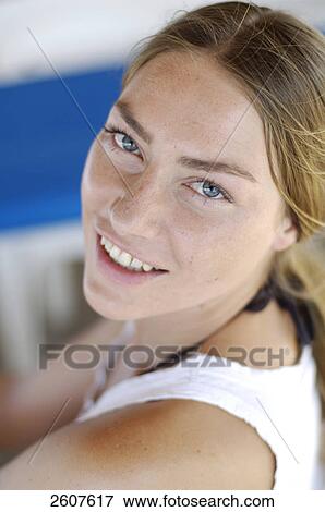 Stock Photo - Portrait of young woman smiling . Fotosearch