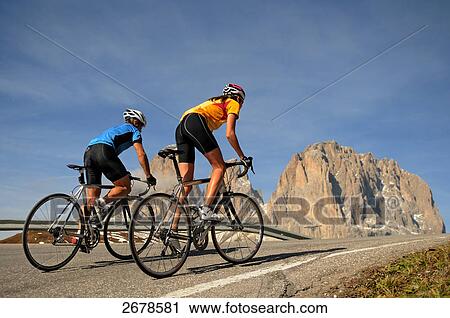Rear view of two mountain bikers cycling together, Dolomites, Italy View Large Photo Image Stock Image - Rear view of two mountain bikers cycling together, Dolomites, Italy . Fotosearch