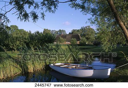 Stock Photo - Rowboat in lake, Selenter See, Schleswig-Holstein, Germany . Fotosearch
