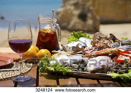 Picture - Sangria and fish, Praia dos Tres Irmaos, Alvor, Algarve, Portugal . Fotosearch
