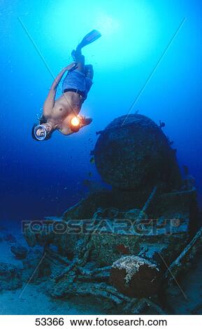 Scuba diver flashing light on shipwreck's engine underwater, Egypt  View Large Photo Image Stock Photograph - Scuba diver flashing light on shipwreck's engine underwater, Egypt . Fotosearch