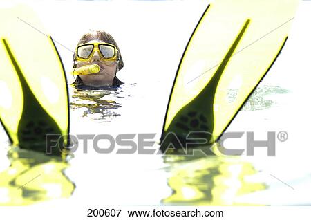 Stock Photo - Scuba diver swimming in sea . Fotosearch