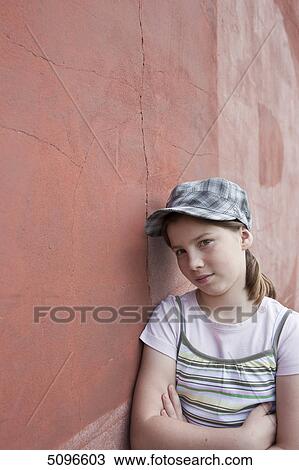 Serious girl leaning at wall, portrait View Large Photo Image Stock Image - Serious girl leaning at wall, portrait . Fotosearch