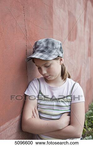 Serious girl leaning at wall View Large Photo Image Stock Image - Serious girl leaning at wall . Fotosearch