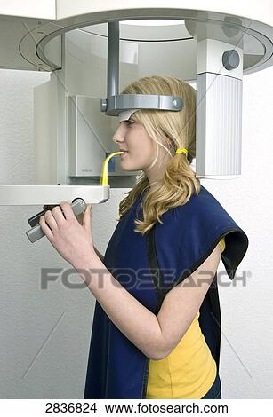 Side profile of teenage girl receiving dental treatment View Large Photo Image Picture - Side profile of teenage girl receiving dental treatment . Fotosearch