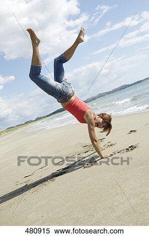 Side profile of woman doing cartwheel on beach View Large Photo Image Stock Photography - Side profile of woman doing cartwheel on beach . Fotosearch