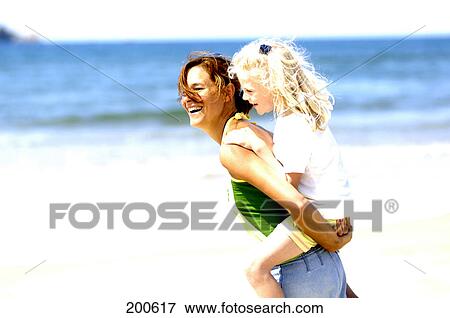 Side profile of woman giving piggyback ride to her daughter View Large Photo Image Stock Photo - Side profile of woman giving piggyback ride to her daughter . Fotosearch