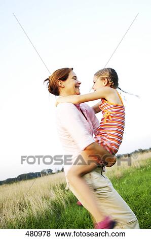 Side profile of woman playing with her mother View Large Photo Image Stock Photo - Side profile of woman playing with her mother . Fotosearch