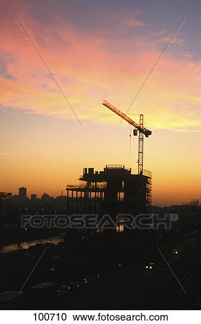 Silhouette of crane at construction site View Large Photo Image Stock Image - Silhouette of crane at construction site . Fotosearch