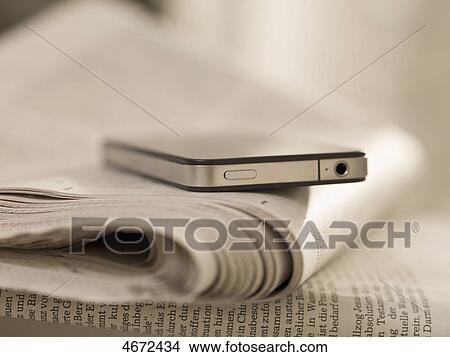 Picture - Smartphone and newspaper . Fotosearch