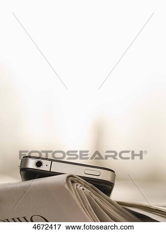 Smartphone and newspaper View Large Photo Image Stock Photo - Smartphone and newspaper . Fotosearch