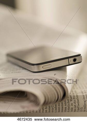 Stock Photography - Smartphone and newspaper . Fotosearch