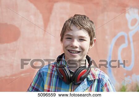 Smiling boy with headphones, portrait View Large Photo Image Stock Photo - Smiling boy with headphones, portrait . Fotosearch