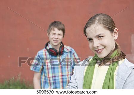 Stock Image - Smiling girl and boy with headphones . Fotosearch