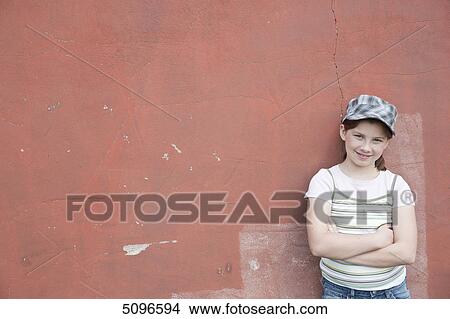 Picture - Smiling girl leaning at wall . Fotosearch