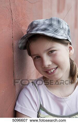 Smiling girl leaning at wall, portrait View Large Photo Image Stock Photo - Smiling girl leaning at wall, portrait . Fotosearch