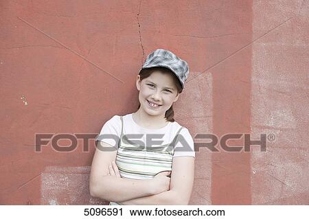 Smiling girl leaning at wall View Large Photo Image Stock Image - Smiling girl leaning at wall . Fotosearch